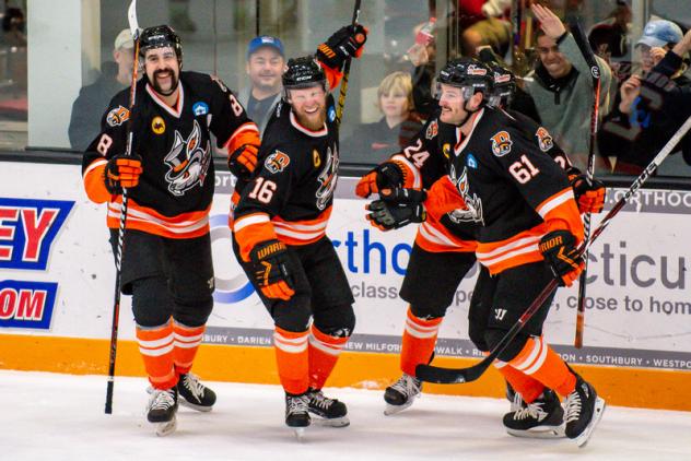 Danbury Hat Tricks celebrate a goal against the Battle Creek Rumble Bees