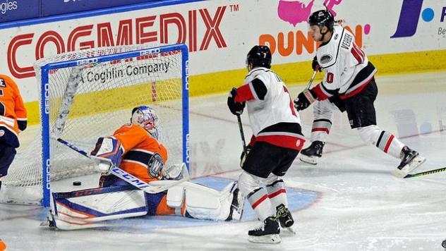 Hayden Verbeek of the Adirondack Thunder (right) scores against Worcester Railers HC