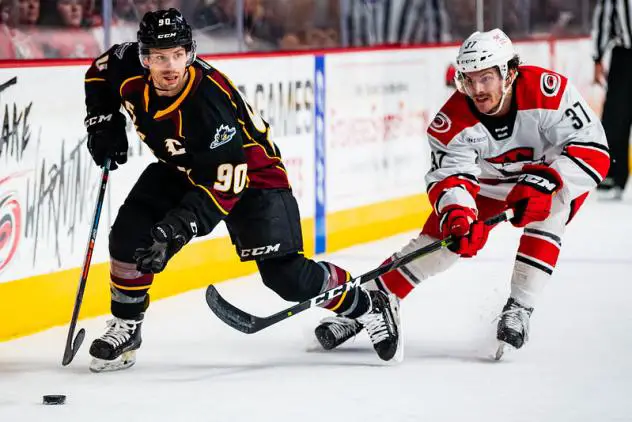 Cleveland Monsters left wing Nathan Gerbe (left) vs. the Charlotte Checkers