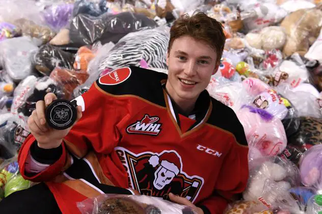 Calgary Hitmen forward Carson Focht in a pile of teddy bears