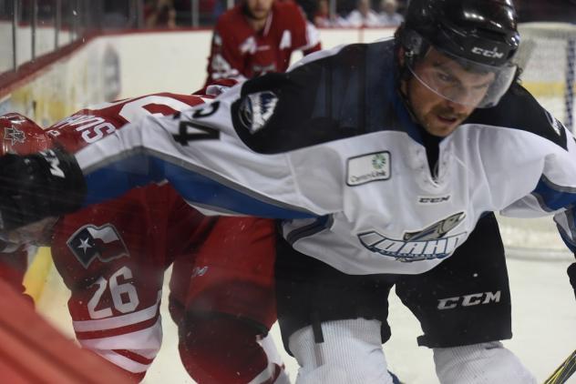 Spencer Asuchak of the Allen Americans (left) battles the Idaho Steelheads