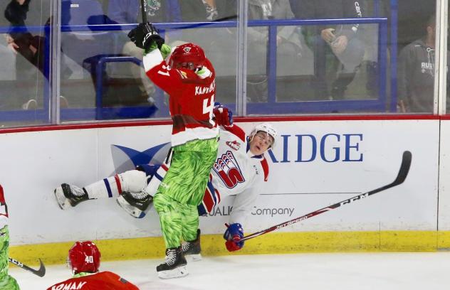 Vancouver Giants defenceman Bowen Byram slams a Spokan Chief into the boards