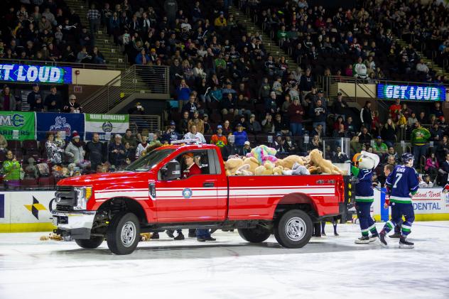 Maine Mariners pick up toys from their Teddy Bear Toss