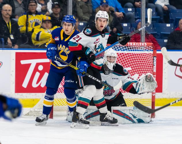 Kelowna Rockets defenceman Jake Lee (right) vs. the Saskatoon Blades