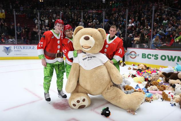 Vancouver Giants pose with a giant teddy bear
