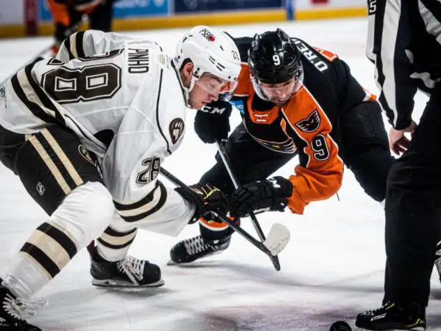 Lehigh Valley Phantoms center Cal O'Reilly (right) faces off with the Hershey Bears