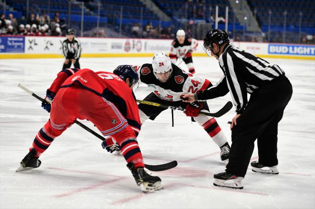 Binghamton Devils right wing Ludvig Larsson (right) faces off against the Hartford Wolf Pack