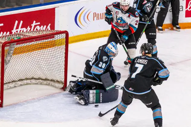 Kelowna Rockets centre Matthew	Wedman (top) takes a shot against the Winnipeg ICE