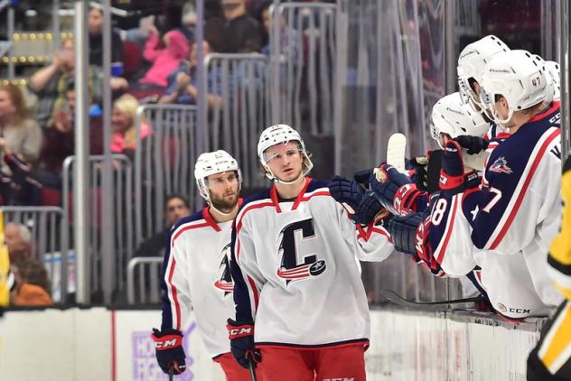 Cleveland Monsters exchange congratulations along the bench