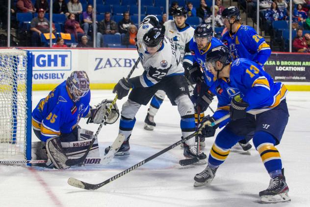 Tulsa Oilers goaltender Devin Williams tries to hold off the Wichita Thunder