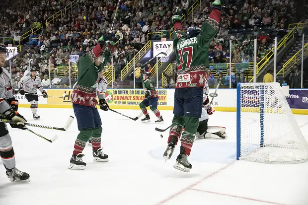 Michael Huntebrinker of the Florida Everblades (right) leaps into the air following a score against the Kansas City Mavericks