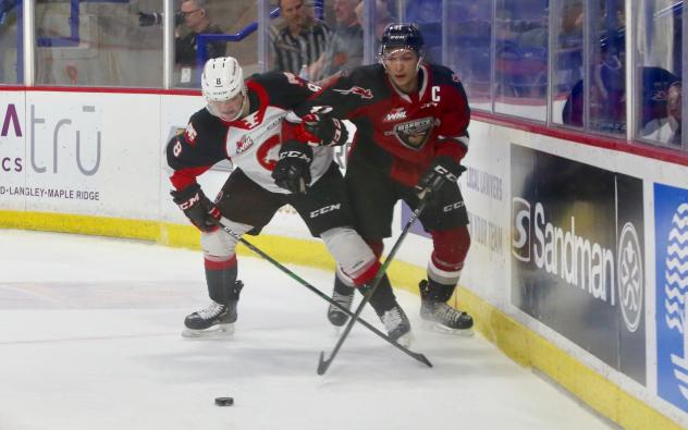 Vancouver Giants defenceman Alex Kannok Leipert (right) battles along the boards vs. the Prince George Cougars