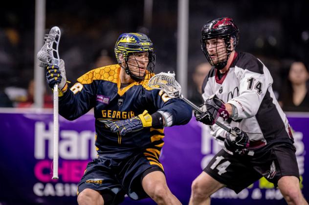 Zed Williams of the Georgia Swarm (left) vs. the Colorado Mammoth