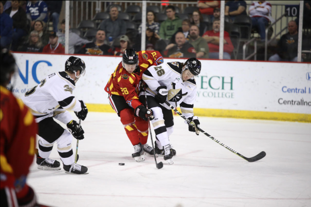 Wheeling Nailers defenseman Spencer Trapp (right) battles the Indy Fuel