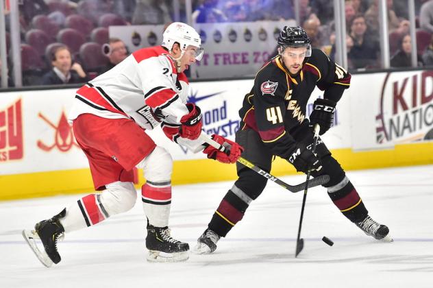 Cleveland Monsters right wing Maxime Fortier (right) vs. the Charlotte Checkers