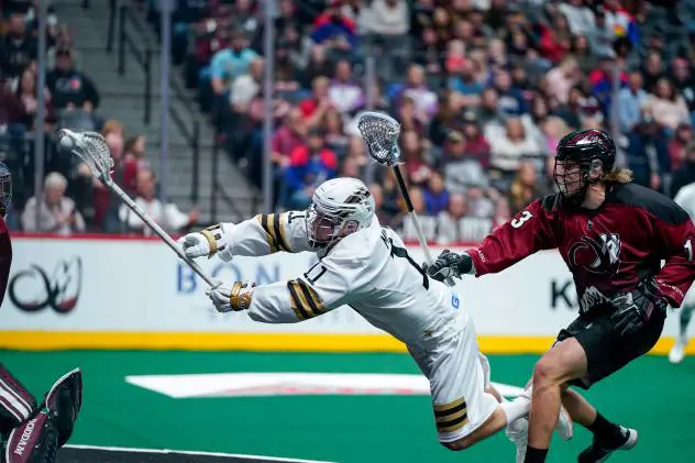 Vancouver Warriors forward Jordan McBride lunges to take a shot against the Colorado Mammoth