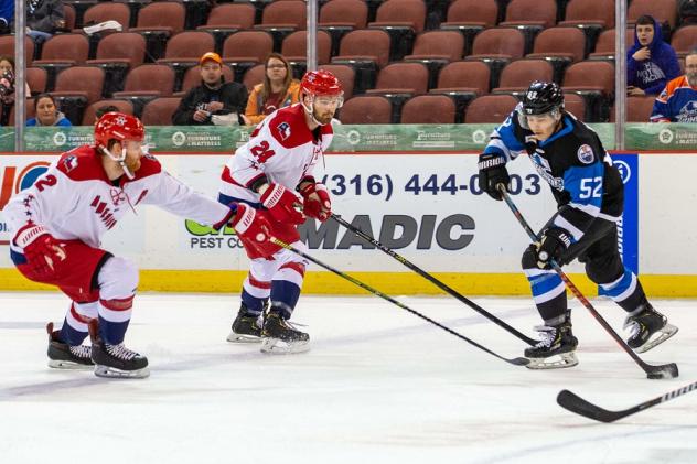 Alleb Americans defensemen Kayle Doetzel and Nick Boka (center) vs. the Wichita Thunder