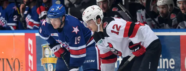 Binghamton Devils right wing Nick Merkley(right) vs. the Rochester Americans
