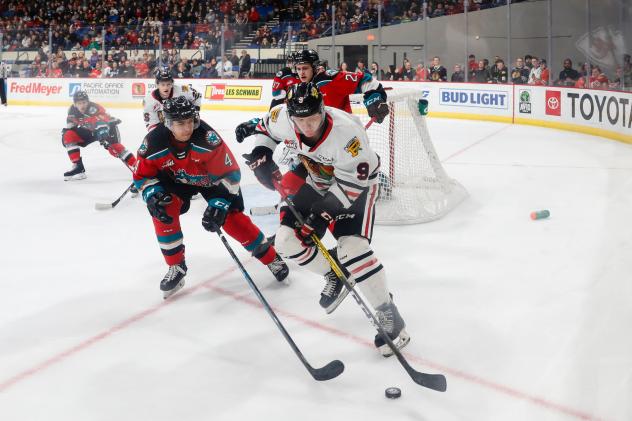 Kelowna Rockets defenceman Devin Steffler (left) vs. the Portland Winterhawks