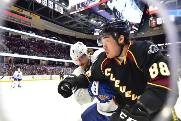 Cleveland Monsters right wing Kole Sherwood (right) vs. the Toronto Marlies