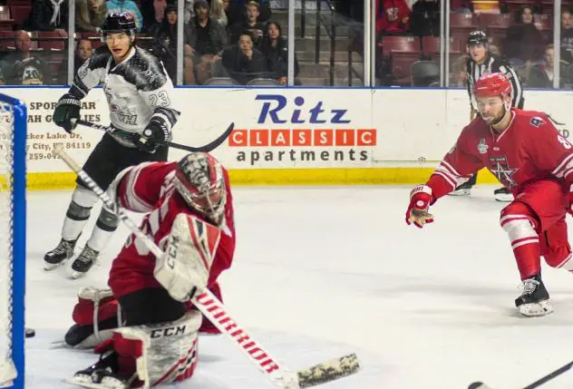 Allen Americans goaltender Jake Paterson lunges for a puck against the Utah Grizzlies