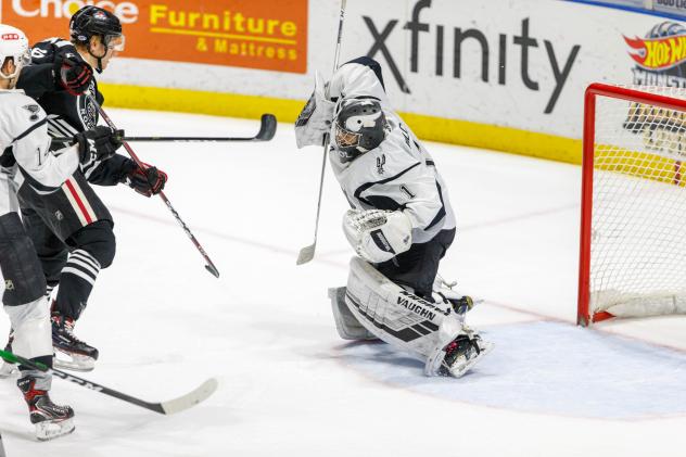 San Antonio Rampage goaltender Adam Wilcox stops the Rockford IceHogs' Alexandre Fortin