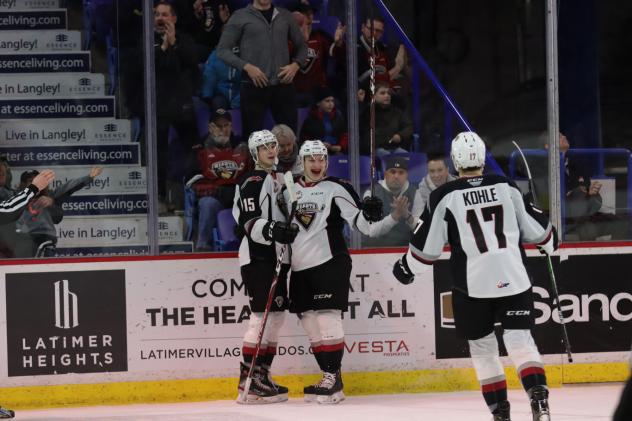 Vancouver Giants right wing Justin Lies and center Eric Florchuk celebrate with centre Kaden Kohle
