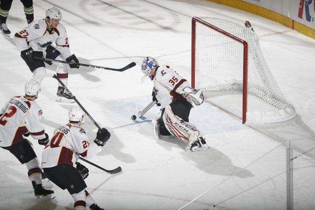 Cleveland Monsters goaltender Veini Vehvilainen handles the puck against the Chicago Wolves