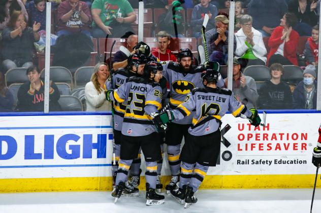 Utah Grizzlies celebrate a win in their Batman jerseys