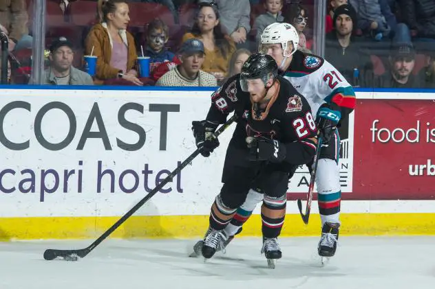 Kelowna Rockets right wing Jonas Peterek (right) vs. the Calgary Hitmen