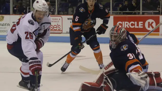 Greenville Swamp Rabbits goaltender Jeremy Helvig lunges for a puck against the South Carolina Stingrays