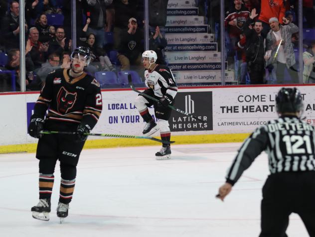 Vancouver Giants forward Justin Sourdif (back) vs. the Calgary Hitmen