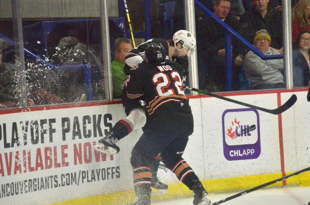 Vancouver Giants get slammed against the boards by the Calgary Hitmen