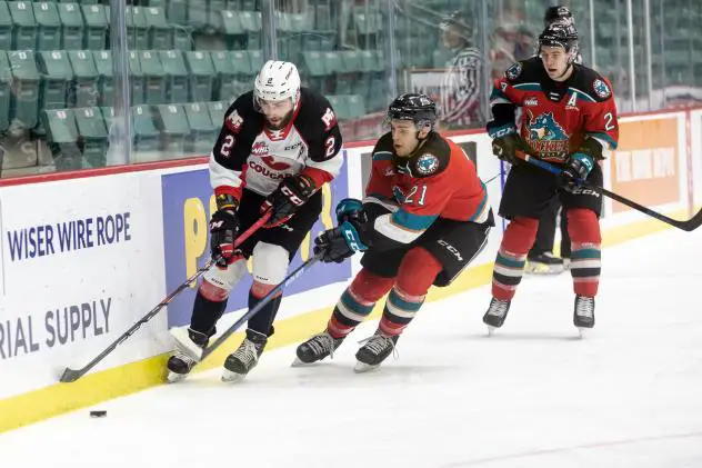 Kelowna Rockets Jake Lee (middle) and Kyle Topping (right) vs. the Prince George Cougars