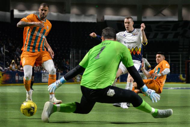 Nick Perera of the Tacoma Stars slides a goal past Florida Tropics goalkeeper Hugo Silva