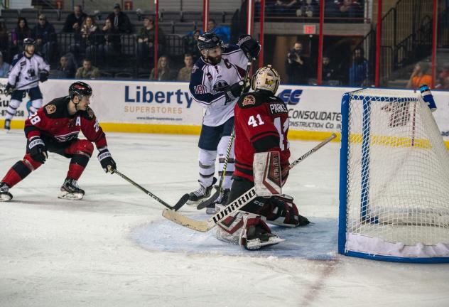 Tulsa Oilers forward Adam Pleskach (center) vs. the Rapid City Rush