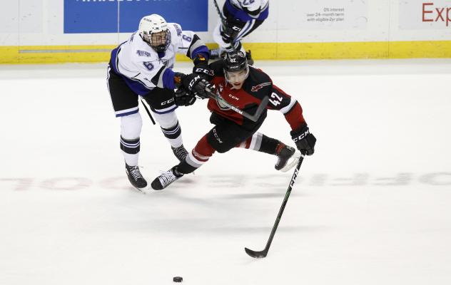Vancouver Giants centre Justin Sourdif (right) battles for the puck against the Victoria Royals