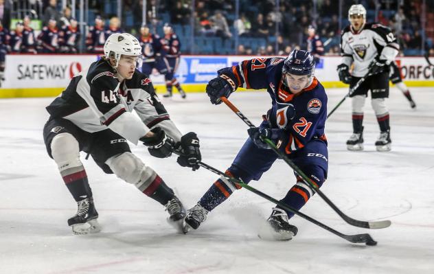 Vancouver Giants defenceman Bowen Byram (left) battles the Kamloops Blazers for the puck