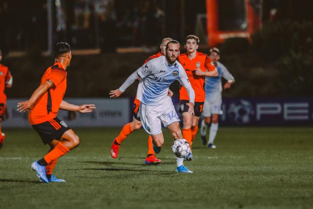 El Paso Locomotive FC forward Marios Lomis eyes the ball against Orange County SC