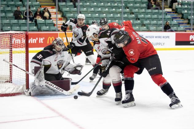 Vancouver Giants goaltender Trent Miner and defenceman Alex Kannok Leipert defend against the Prince George Cougars