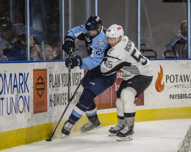Andreas Borgman of the San Antonio Rampage (right) throws a hit on Milwaukee Admirals defenseman Ben Harpur