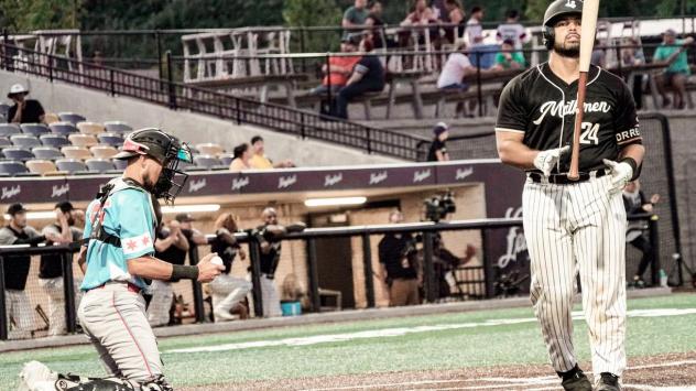 Milwaukee Milkmen catcher Christian Correa (right) walks away from the plate