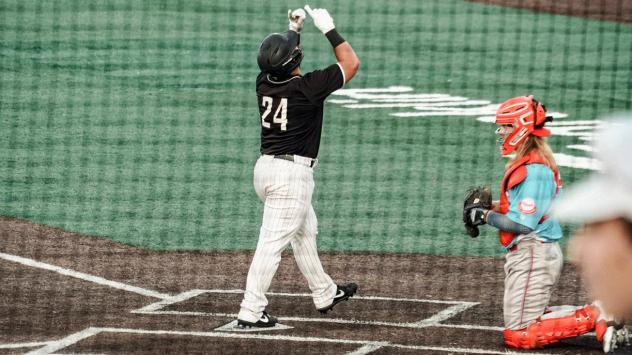 Milwaukee Milkmen catcher Christian Correa crosses the plate following his third inning homer