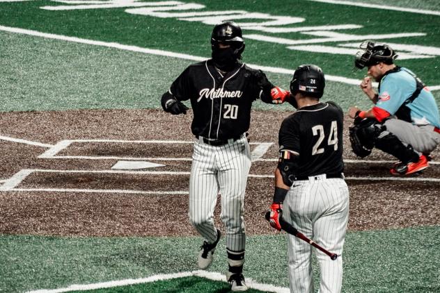 Milwaukee Milkmen outfielder Adam Brett Walker (20) receives congratulations from catcher Christian Correa