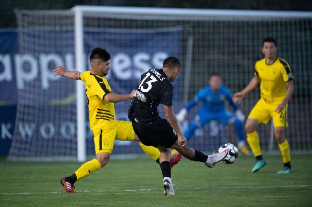 Aidan Daniels of Colorado Springs Switchbacks FC unleashes a shot against New Mexico United