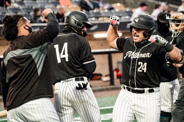 Milwaukee Milkmen exchange congratulations during Game 1 of the American Association Championship Series