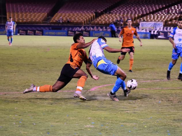 Las Vegas Lights FC midfielder Javan Torre is dragged down in the box by OCSC's Ronald Alexis Cerritos