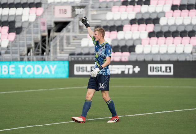 Forward Madison FC goalkeeper Chris Brady