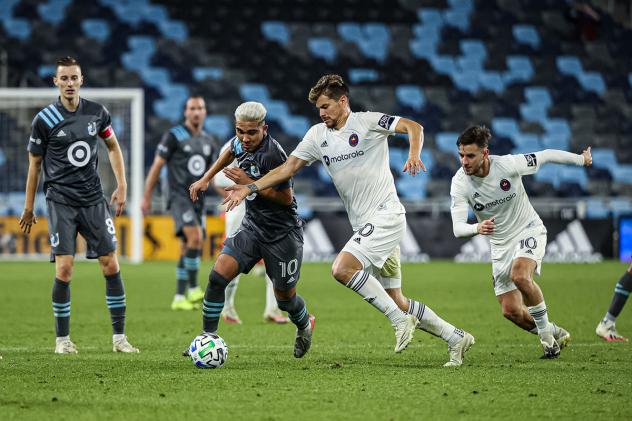Chicago Fire FC vie for possession against Minnesota United
