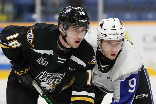 Saint John Sea Dogs left wing Charles Savoie (right) faces off with the Cape Breton Eagles